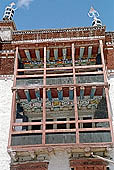 Ladakh - Hemis Gompa, the main monastery halls with the characteristc red painted windows and woden balconies on white washed faades 